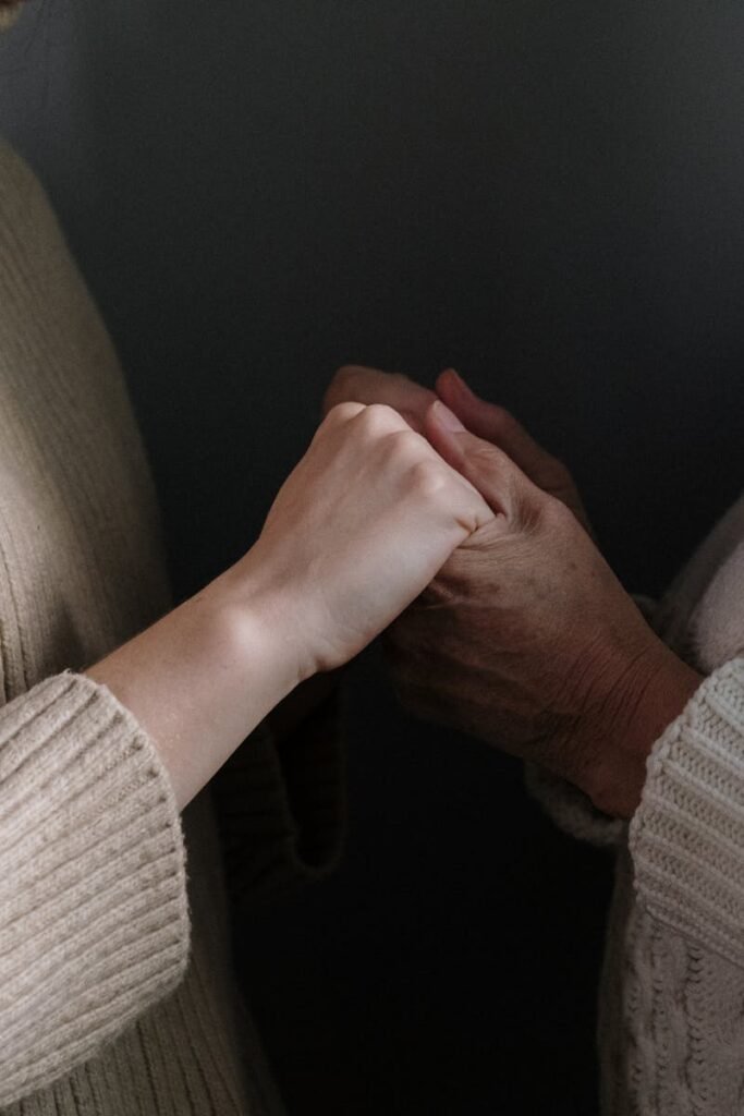 pexels-photo-5493791-5493791 A close-up of two people holding hands, emphasizing warmth and connection.